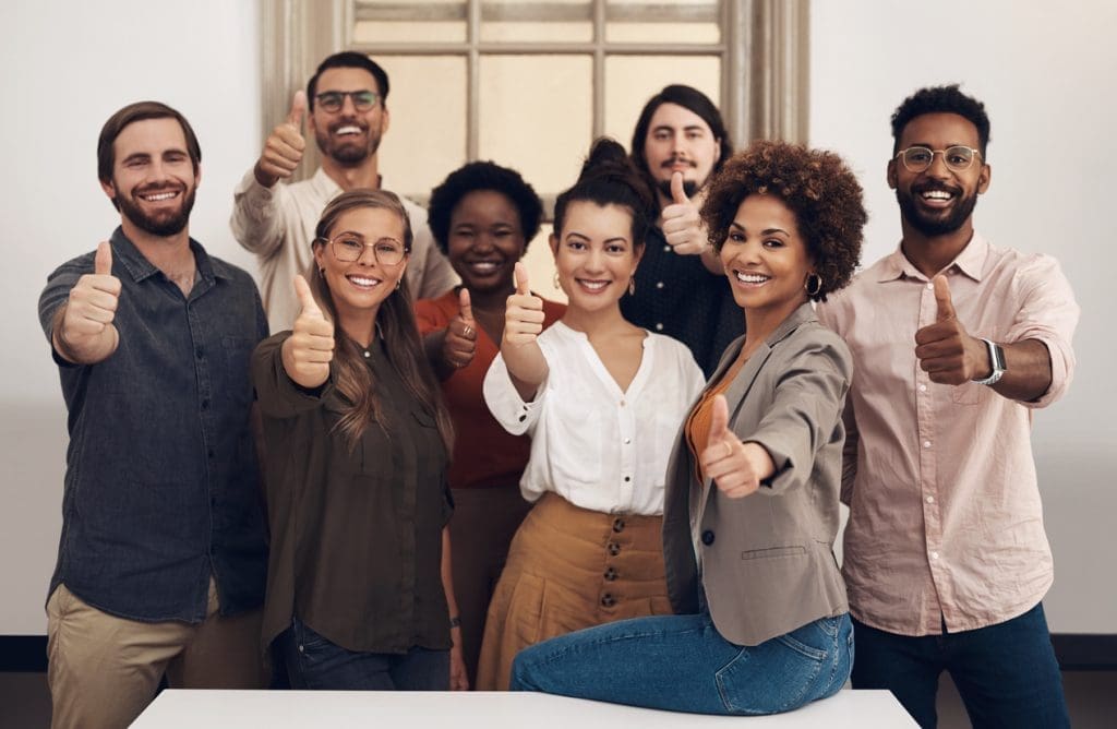 a group of people giving the thumbs up sign.