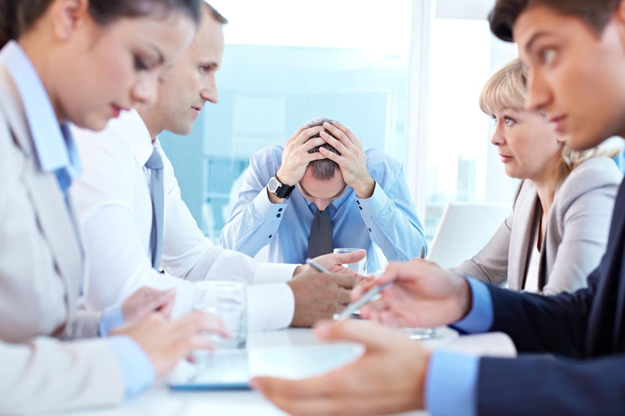 a group of business people sitting around a table.