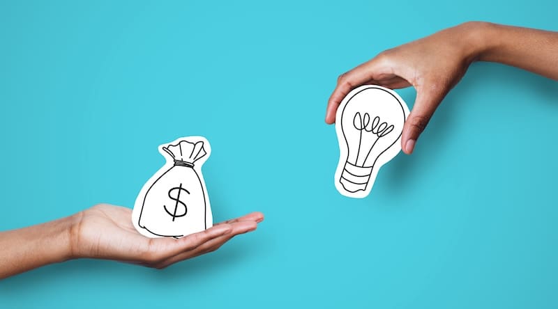 Two hands against a blue background: one holds a paper cutout of a money bag with a dollar sign, and the other holds a lightbulb, representing exchanging money for ideas—highlighting Online Reputation Management costs.