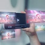 A hand holds a smartphone displaying multiple floating video play screens with progress bars and play buttons, symbolizing streaming or virtual media content—hinting at what is the Streisand effect when online videos go viral, against a blurred background.