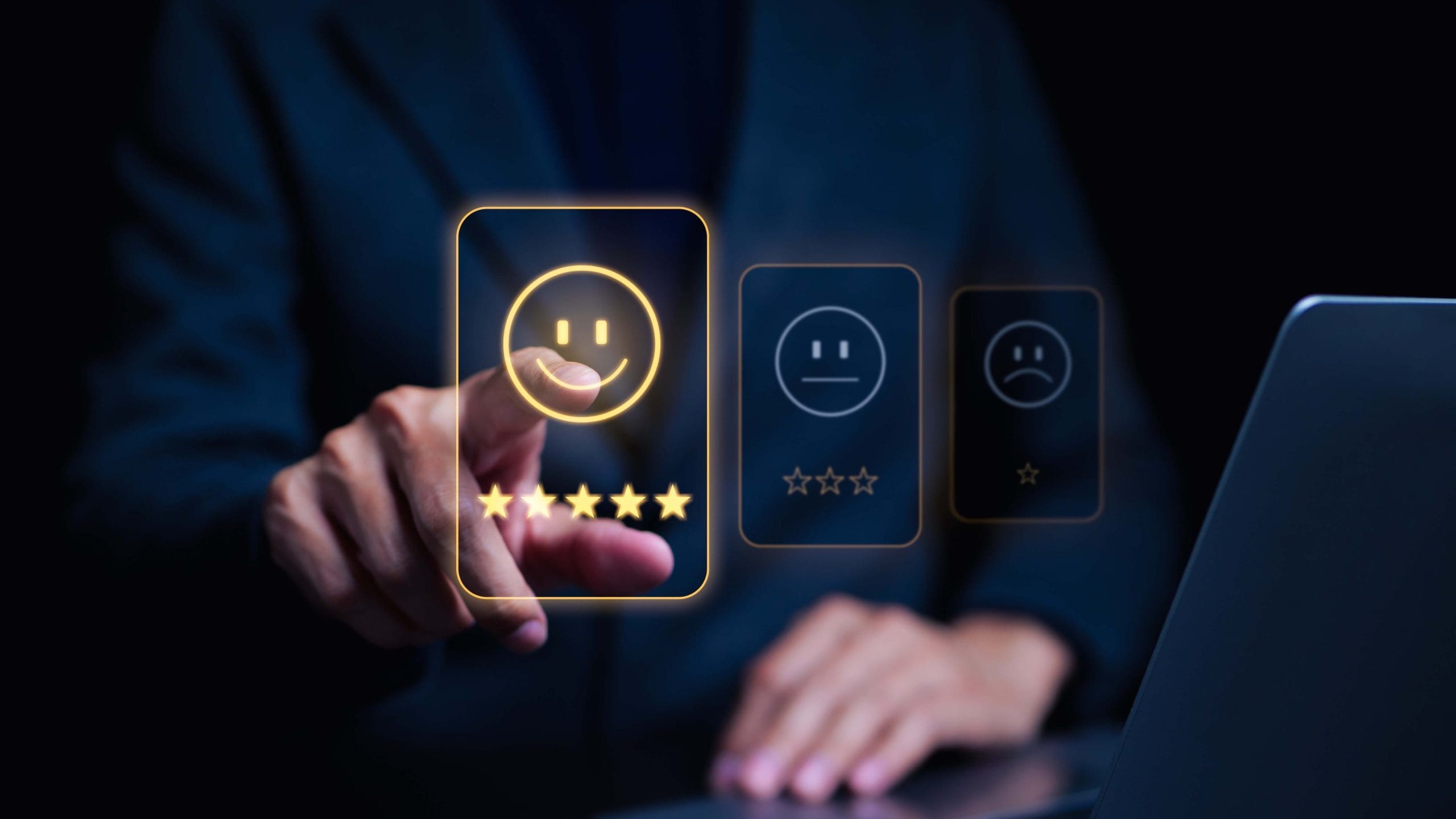 A businessman is pointing at a laptop displaying an online reputation management smiley face.