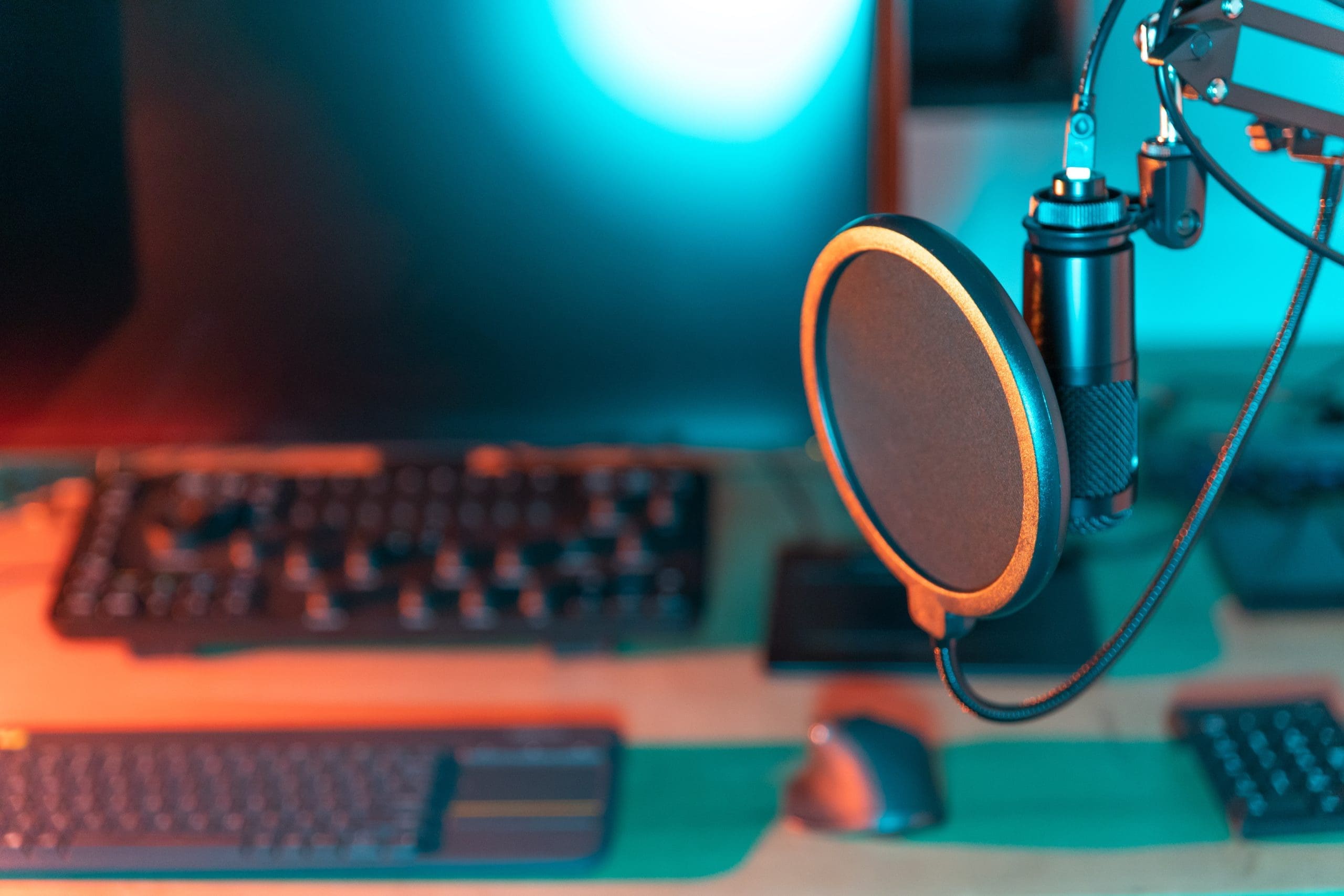 A podcast microphone sits on a desk next to a computer, highlighting the importance of reputation management for podcasters.