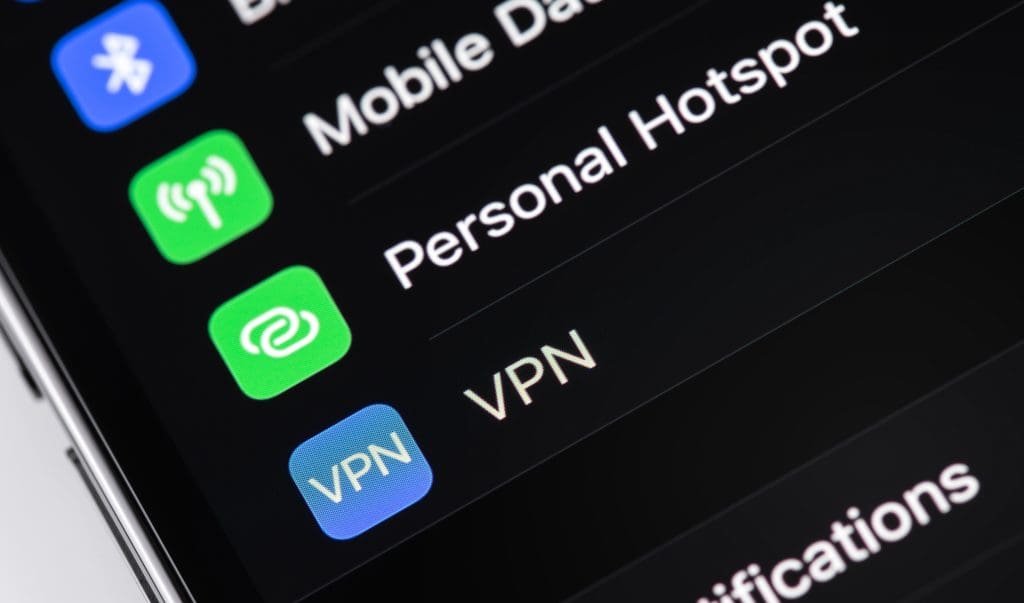 A close-up of a smartphone screen displaying settings options, including Mobile Data, Personal Hotspot, and VPN, with colorful icons beside each option.