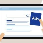 Illustration of hands holding a tablet displaying a search engine results page, with one hand tapping on a blue "Ads" icon next to the search results. Papers are scattered in the background.