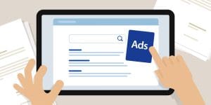 Illustration of hands holding a tablet displaying a search engine results page, with one hand tapping on a blue "Ads" icon next to the search results. Papers are scattered in the background.