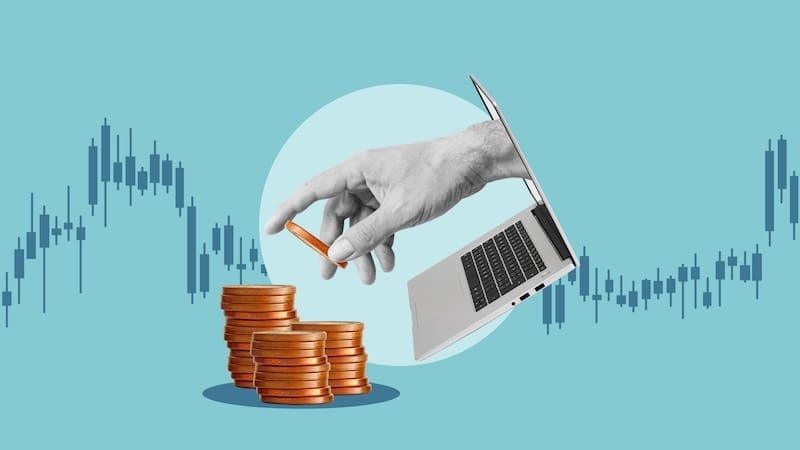 A hand reaches out from a laptop screen to place a coin on a stack of coins, with financial charts in the background, symbolizing online investing, digital finance, and effective reputation management.