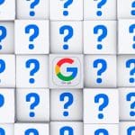 A grid of white cubes with blue question marks, except for one central cube displaying the colorful Google "G" logo.
