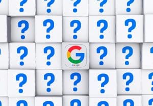 A grid of white cubes with blue question marks, except for one central cube displaying the colorful Google "G" logo.