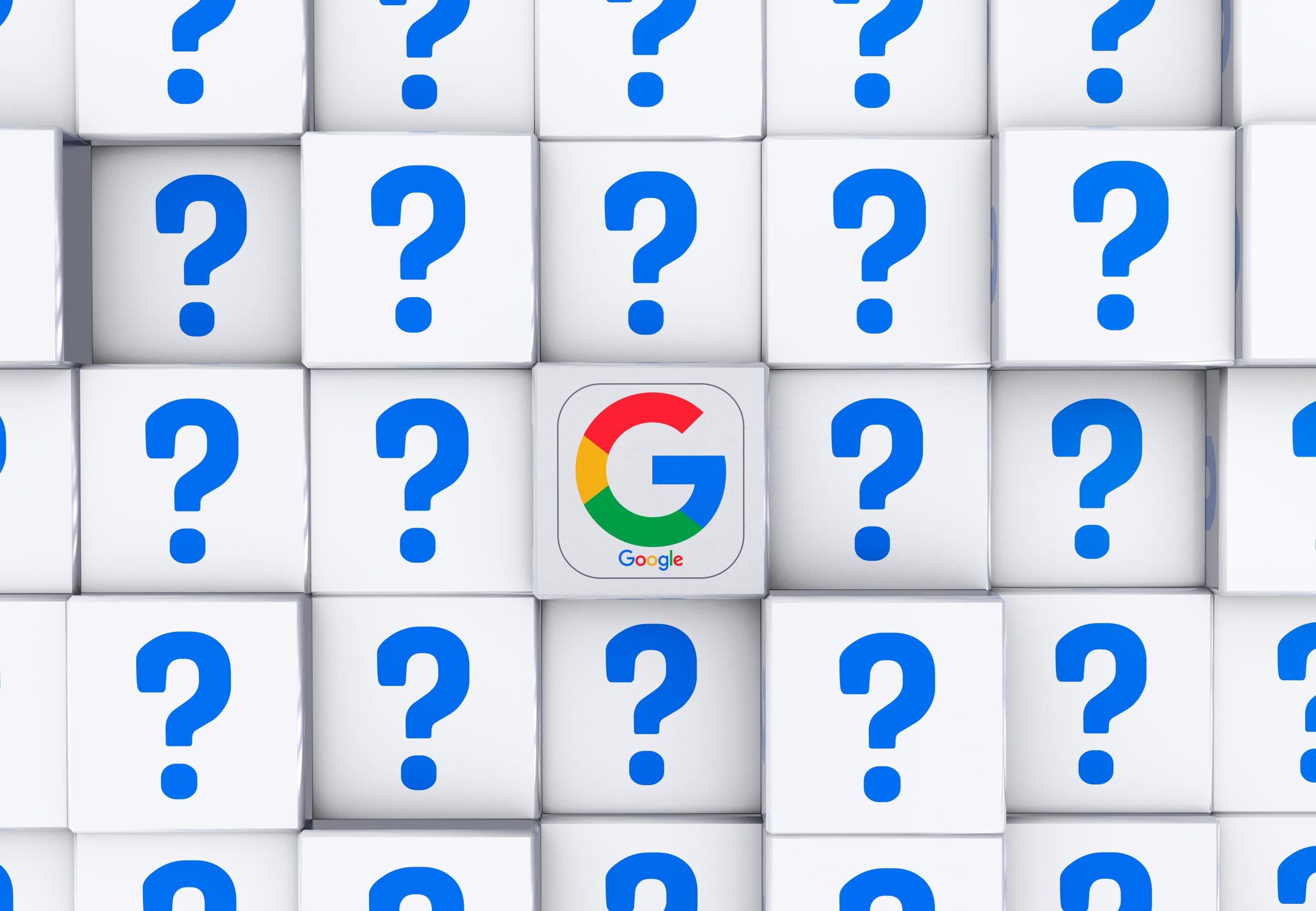 A grid of white cubes with blue question marks, except for one central cube displaying the colorful Google "G" logo.