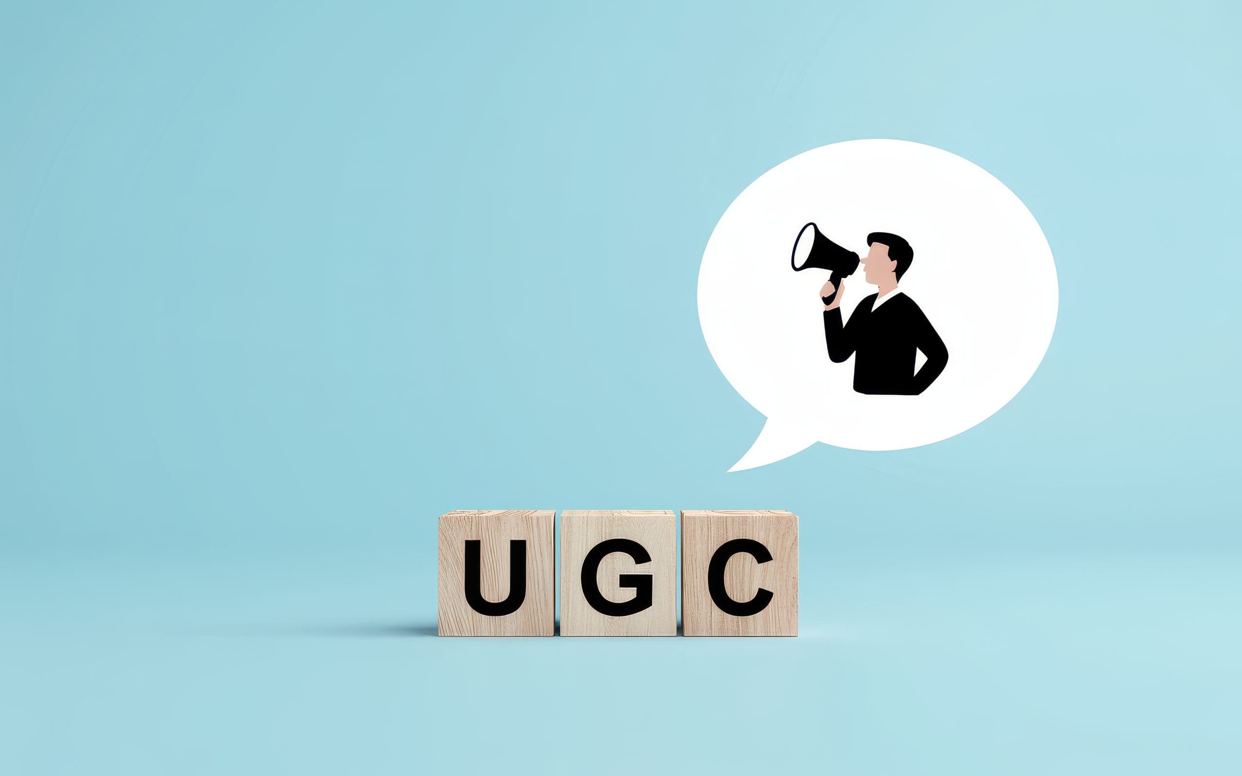 Wooden blocks spelling “UGC” sit on a blue background. Above them is a speech bubble containing an illustrated person holding a megaphone, symbolizing user-generated content or user voices.